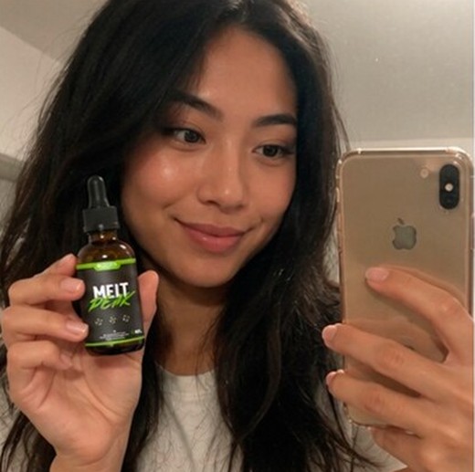 MeltPeakDrop customer holding a bottle, photo 5
